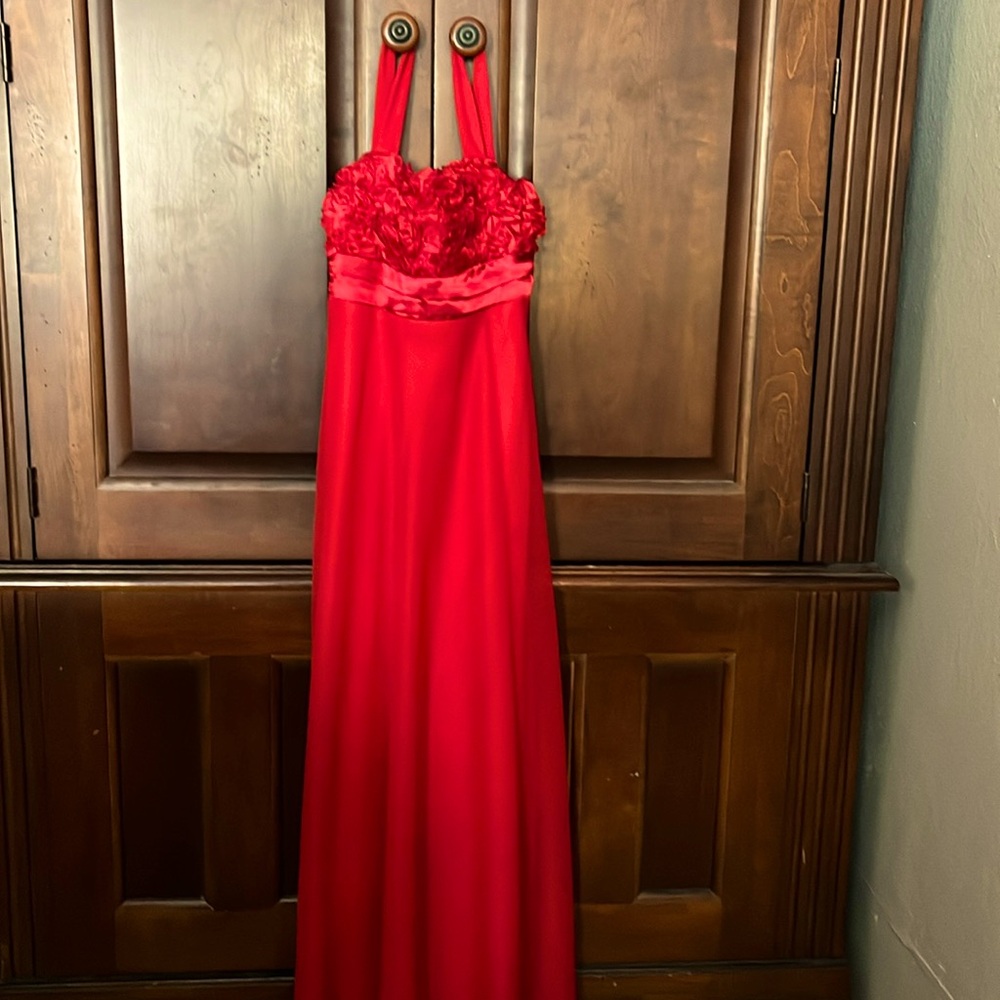 This dress is by Ruby Rox size large for a 10 to 12-year-old. RED dress.